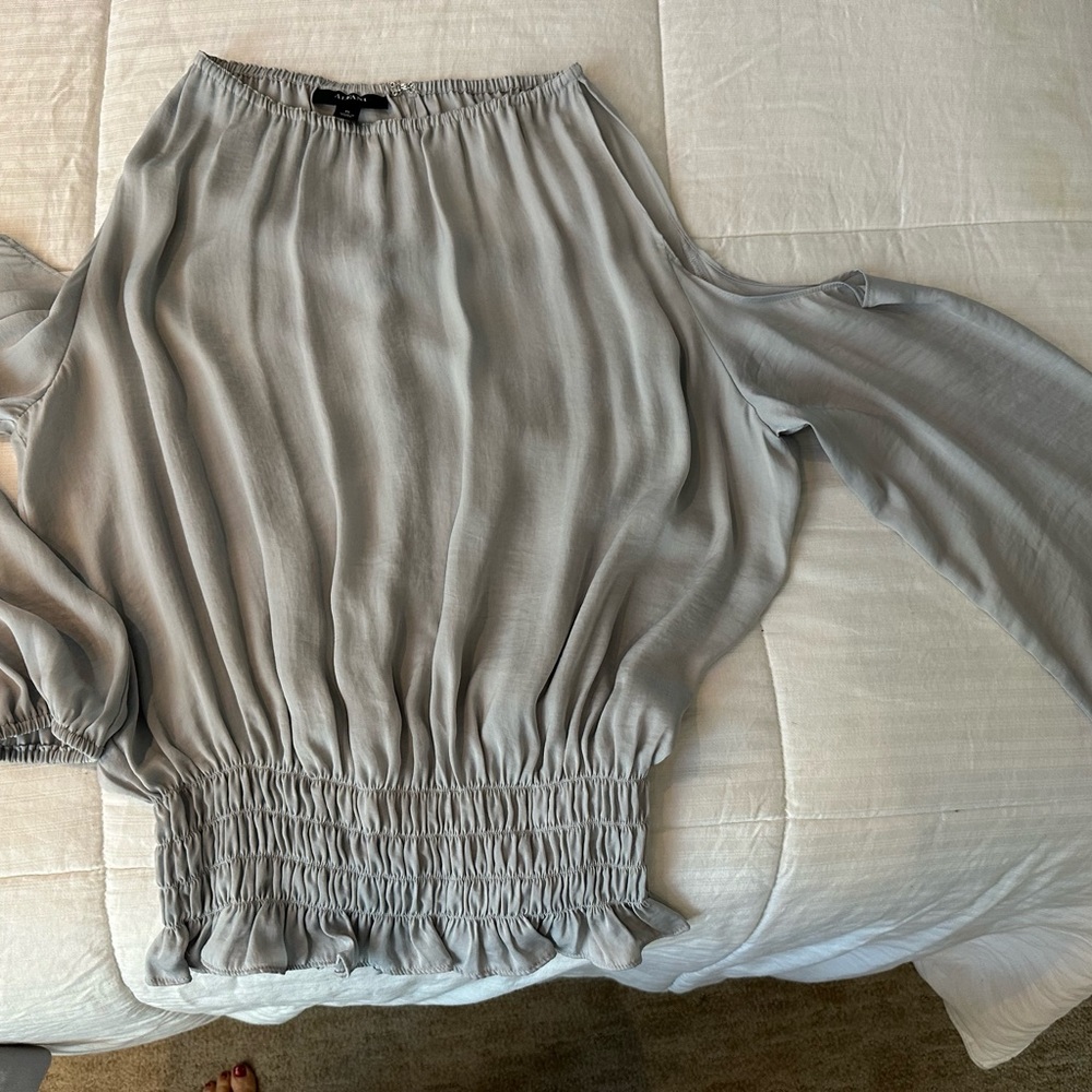 Women’s top with peek a boo sleeves.